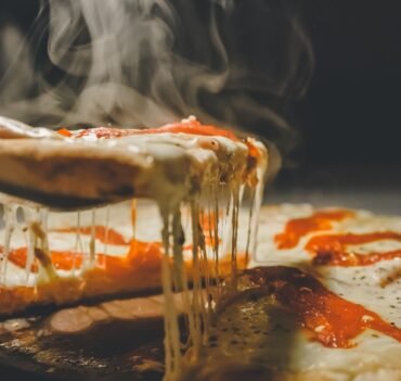 close up photo of pizza with cheese
